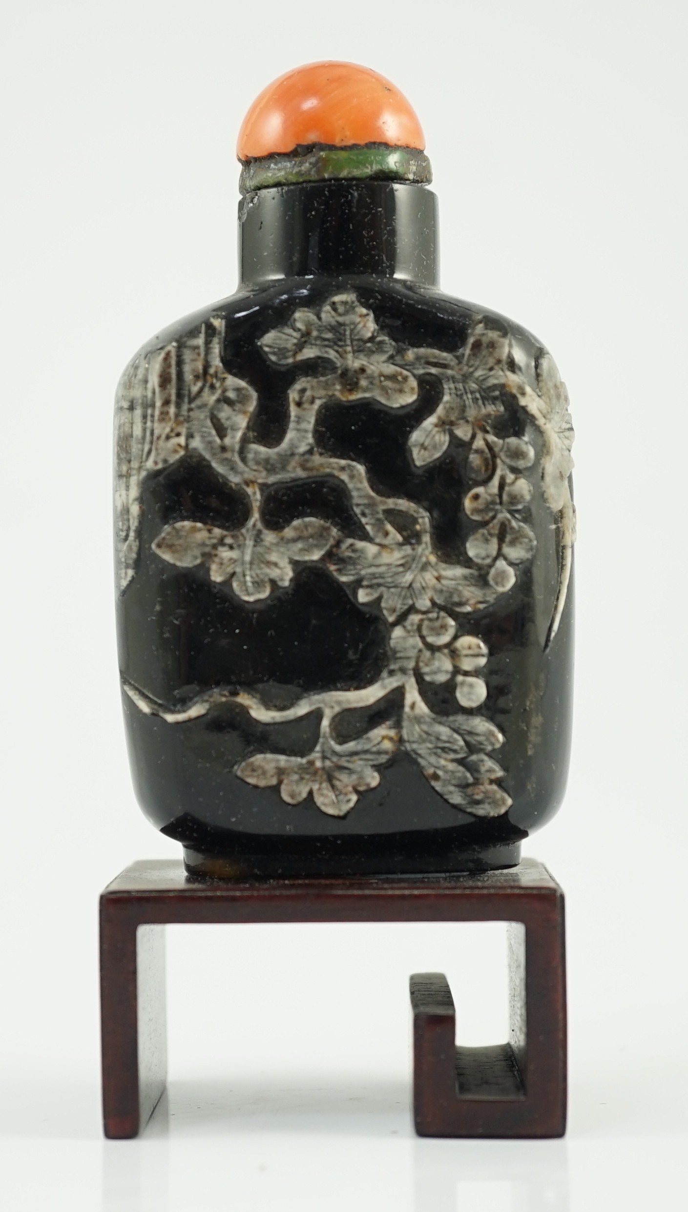 A Chinese smoky quartz snuff bottle, 1780-1820, 6.7cm high, coral stopper